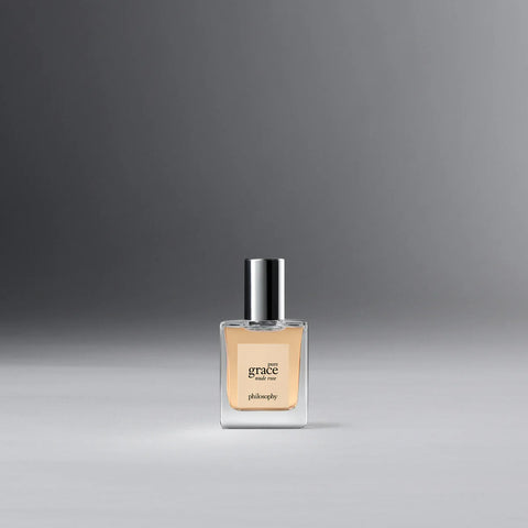 Philosophy Pure Grace Nude Rose perfume bottle with clear glass and silver cap on gray background