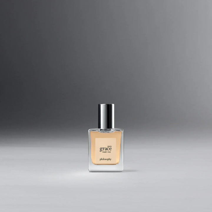Philosophy Pure Grace Nude Rose perfume bottle with clear glass and silver cap on gray background