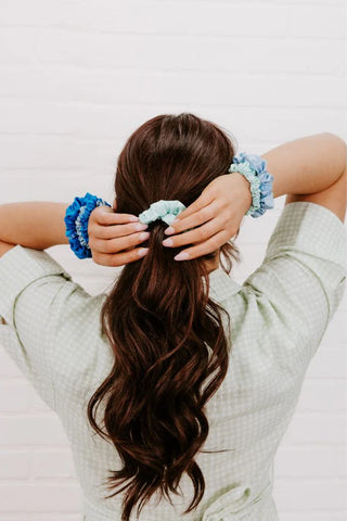 Teleties silk hair scrunchies for women in blue and green tones holding back beautiful hair.