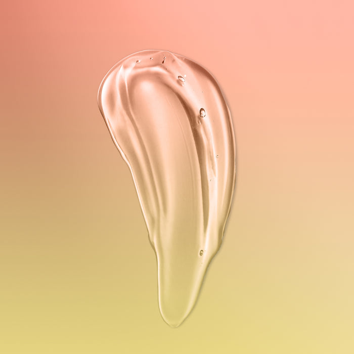 Clear gel texture of St. Tropez self-tan bronzing water on gradient pink and yellow background