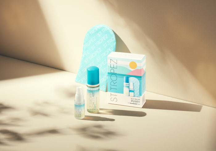 St. Tropez self tan kit with applicator mitt and two small bottles in bright natural light