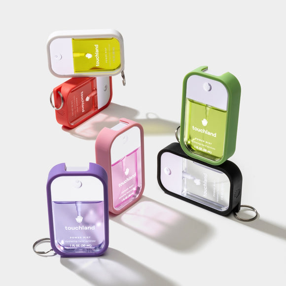 Touchland hand sanitizer mist in various colors with keychain attachment for easy portability