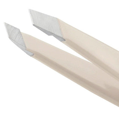 Close-up of Tweezerman micro tweezer with angled precision tips in beige and silver