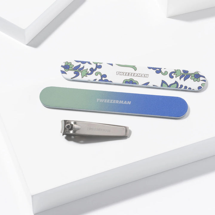 Tweezerman nail care products including a nail clipper and two nail files in decorative designs