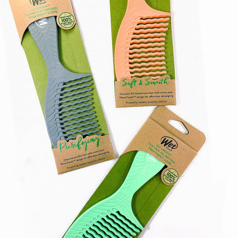 Wet Brush Eco-Friendly Comb in assorted colors with charcoal and tea tree infused treatment packaging