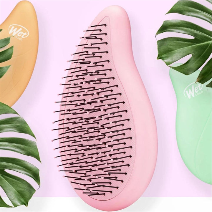 Wet Brush palm detangler in pink with flexible bristles for smooth hair detangling