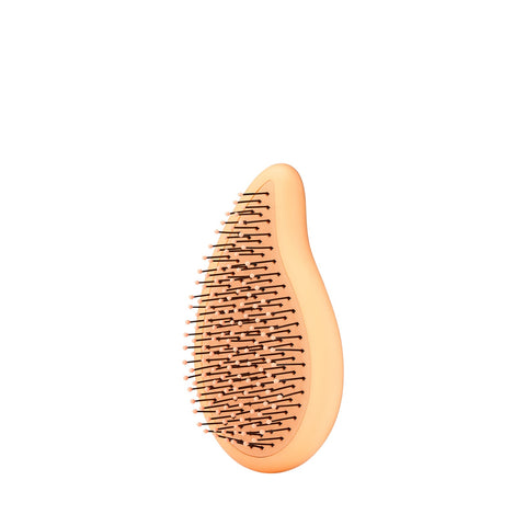 Wet Brush palm detangler in peach color with flexible bristles for gentle hair detangling
