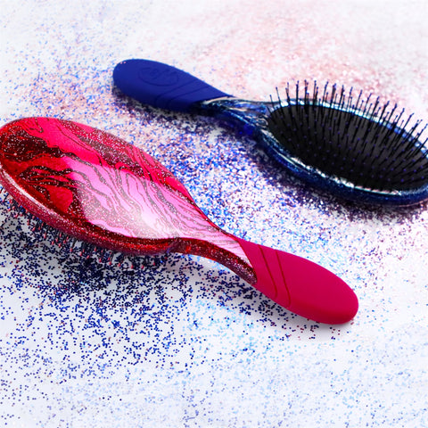 Wet Brush sparkle finish detangling brush with red and blue glitter handles on a white background