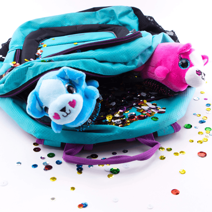 Wet Brush kids detangling hair brush with blue and pink animal plush handles inside a turquoise backpack with colorful sequins