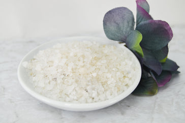 Natural Elephant Lavender Dead Sea Salt in a white bowl with greenery for relaxation and wellness