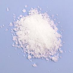 Natural Elephant Dead Sea Salt crystals for natural magnesium bath soak on blue background