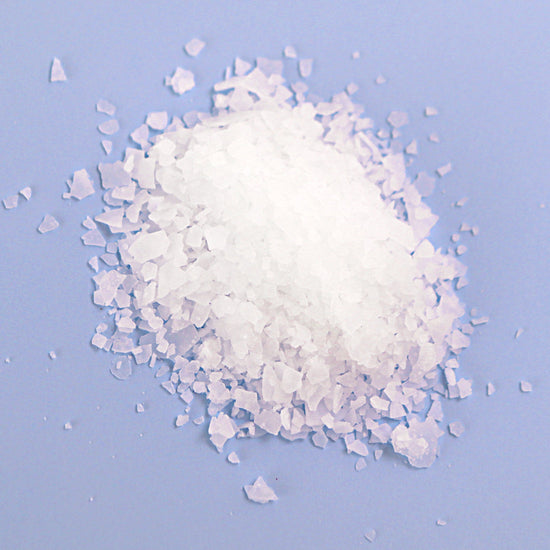 Natural Elephant Dead Sea Salt crystals for natural magnesium bath soak on blue background