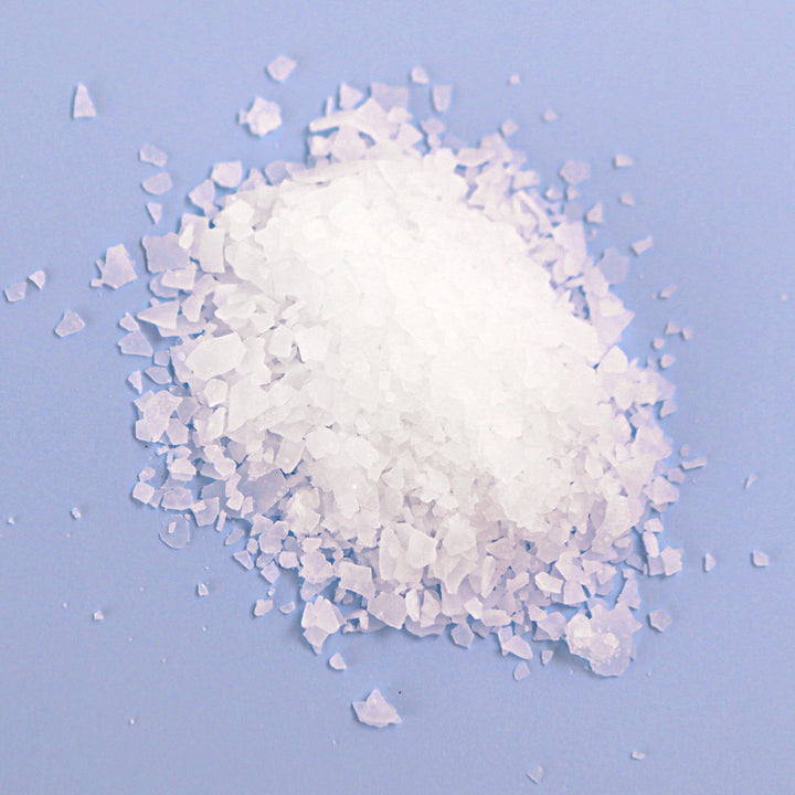 Natural Elephant Dead Sea Salt crystals for natural magnesium bath soak on blue background