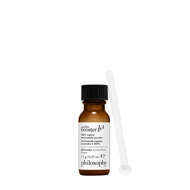 Philosophy niacinamide powder for skin in a small brown bottle with a black cap and a white scoop