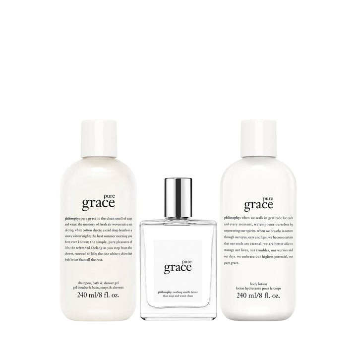 Philosophy Pure Grace gift set with shampoo, body lotion, and cologne in white bottles and clear perfume bottle