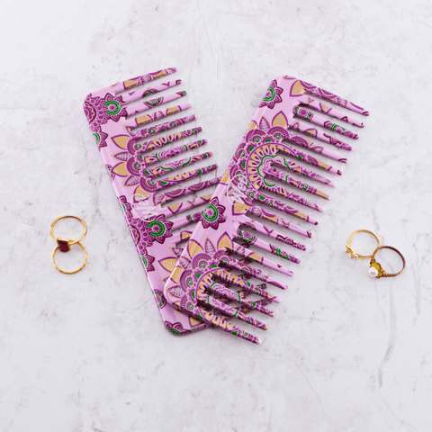 Wet Brush Moroccan print detangler comb featuring a purple and green floral design on a marble surface