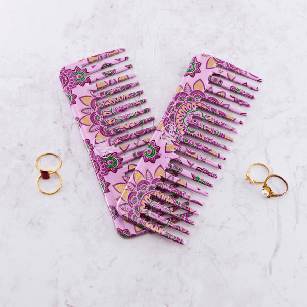 Wet Brush Moroccan print detangler comb featuring a purple and green floral design on a marble surface